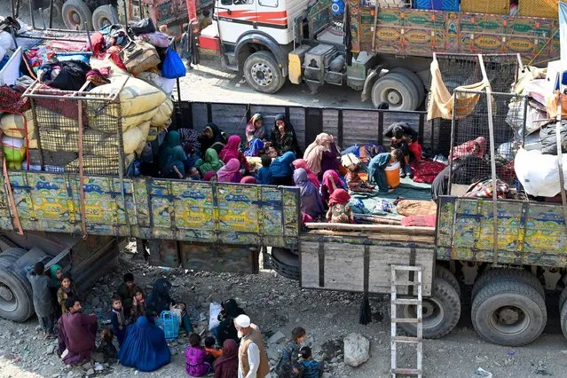 Afghan refugees arrive in trucks from Pakistan at the Afghanistan-Pakistan Torkham border in Nangarhar province on October 30, 2023. Islamabad has issued an order to 1.7 million Afghans it says are living in the country illegally to leave by November 1, or be deported. (Photo by Wakil Kohsar/AFP Photo)