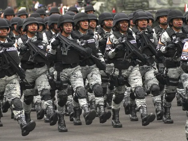National Guards march during the annual Independence Day military parade in the capital's main square, the Zocalo, in Mexico City, Friday, September 16, 2022. (Photo by Marco Ugarte/AP Photo)