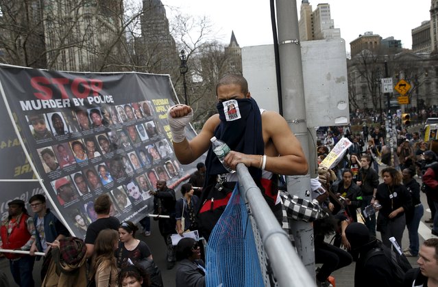 Demonstrators climb over a fence during a protest against police brutality against minorities in New York, April 14, 2015. (Photo by Shannon Stapleton/Reuters)