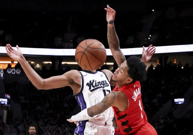 Portland Trail Blazers guard Anfernee Simons, right, knocks the ball loose from Sacramento Kings forward Keegan Murray during the second half of an NBA basketball game Tuesday, December 26, 2023, in Portland, Ore. (Photo by Howard Lao/AP Photo)