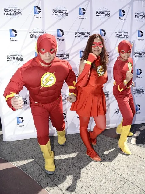 Families arrive dressed as DC Comics Super Heroes at the DC Comics Super Hero World Record Event to set a Guinness World Record at the Hollywood & Highland Center on Saturday, April 18, 2015, in Los Angeles. (Photo by Dan Steinberg/Invision for Warner Bros. Consumer Products/AP Images)