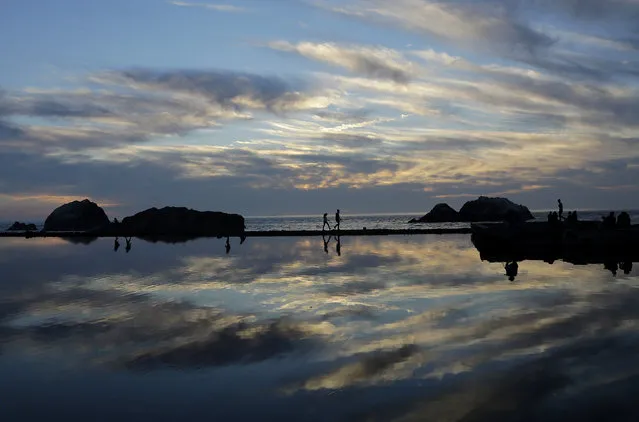 A couple walks along a path at Sutro Baths, once the world's largest indoor swimming pool facility, in San Francisco, Tuesday, February 16, 2016. (Photo by Jeff Chiu/AP Photo)