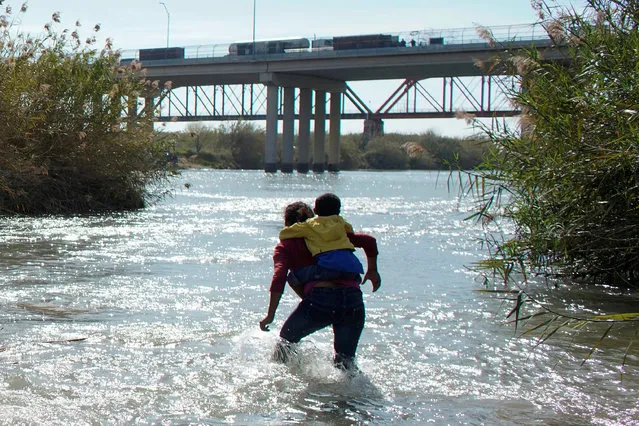 Migrants from Honduras walk in the river as they try to cross the Rio Bravo towards the United States, as seen from Piedras Negras, Mexico, February 16, 2019. (Photo by Alexandre Meneghini/Reuters)