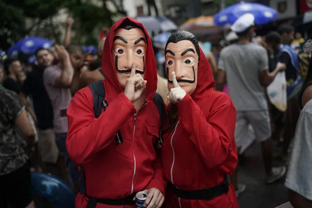 In this Saturday, February 16, 2019 photo, carnival revelers dressed as characters from the movie “La Casa de Papel” pose for a picture during the “Desliga da Justica” block party in Rio de Janeiro, Brazil. “Desliga” means in Portuguese to turn something off, and this street party is a parody of the Justice League. (Photo by Leo Correa/AP Photo)