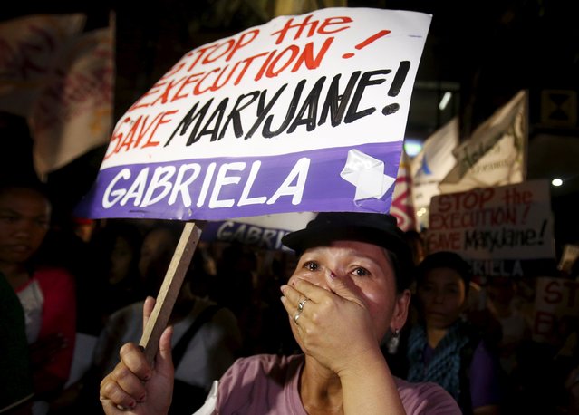 An activist weeps during a candlelight vigil for death row prisoner Mary Jane Veloso outside Indonesian embassy in Makati, Philippines April 28, 2015. The execution of a Filipina drug convict by an Indonesian firing squad will not be delayed despite last-minute appeals by the Philippine government, the attorney general said on Tuesday.Indonesian President Joko Widodo earlier met with a migrant workers' group to discuss the case of Mary Jane Veloso, who is one of nine people set to be executed within hours. (Photo by Erik De Castro/Reuters)