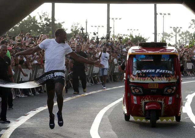 Usain Bolt runs against a moto-taxi as part of a sponsored event in Lima, Peru on April 2, 2019. (Photo by Henry Romero/Reuters)