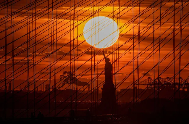 The Statue of Liberty is seen during sunset on November 3, 2021 in New York City. (Photo by Angela Weiss/AFP Photo)