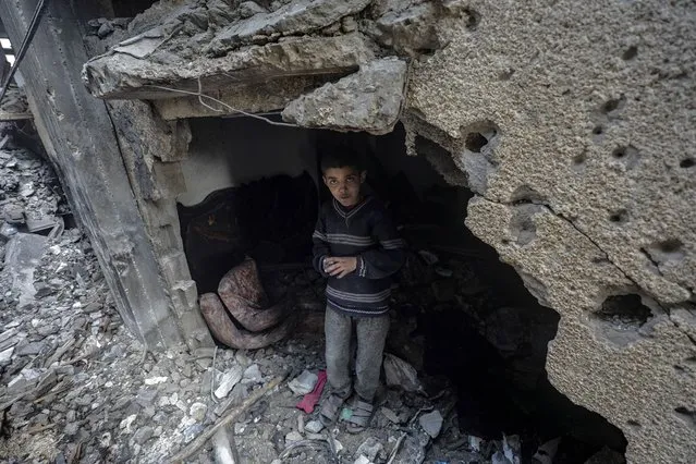 A Palestinian boy stands among the rubble of a destroyed house following an Israeli air strike, in Deir Al Balah, southern Gaza Strip, 08 March 2024. More than 30,000 Palestinians and over 1,300 Israelis have been killed, according to the Palestinian Health Ministry and the Israel Defense Forces (IDF), since Hamas militants launched an attack against Israel from the Gaza Strip on 07 October 2023, and the Israeli operations in Gaza and the West Bank which followed it. (Photo by Mohammed Saber/EPA)