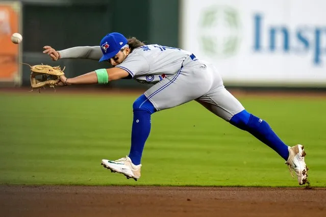 Toronto Blue Jays shortstop Bo Bichette can't reach a line drive by Houston Astros' Yainer Diaz, who singled during the first inning of a baseball game Wednesday, April 3, 2024, in Houston. (Photo by Eric Christian Smith/AP Photo)