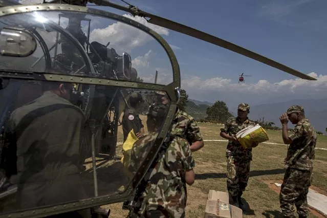 Nepal Military personnel load relief supplies onto an Nepalese helicopter at Charikot Village, in Dolakha, Nepal, May 14, 2015. (Photo by Athit Perawongmetha/Reuters)