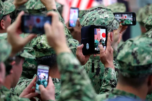 US troops take pictures of US President Donald Trump and First Lady Melania Trump onboard Japan Maritime Self-Defense Force's (JMSDF) helicopter carrier DDH-184 Kaga at JMSDF Yokosuka base in Yokosuka on May 28, 2019. (Photo by Athit Perawongmetha/AFP Photo)