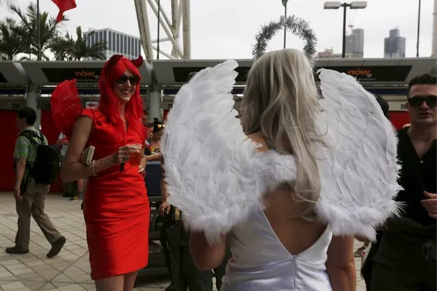 Rugby Union, Hong Kong Sevens, Hong Kong Stadium on April 9, 2016: Fans dressed as angels chat. (Photo by Bobby Yip/Reuters)