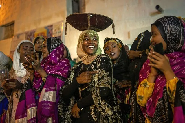 Young women dressed in traditional attires sing and dance during the celebration for the Shuwalid festival in Harar, Ethiopia on April 16, 2024. (Photo by Michele Spatari/AFP Photo)