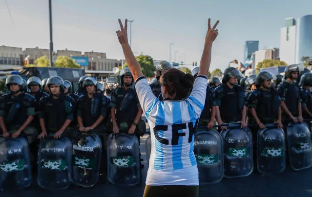 A supporter of the Argentinian former president Cristina Fernandez de Kirchner protests in front of police who guard the courts of Comodoro Py in Buenos Aires, Argentina, 07 March 2017. Fernandez de Kirchner arrived in the federal courts of Buenos Aires to testify in a case in which she is charged with alleged money laundering and bribery allegedly committed through the family company Los Sauces. (Photo by David Fernandez/EPA)
