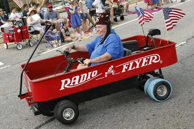 A member of the local Shriners Club performs tricks in a special trick car during Colbert's 50th annual Independence celebration in Colbert, Georgia on July 4, 2019. (Photo by Joshua L. Jones/Athens Banner-Herald via AP Photo)