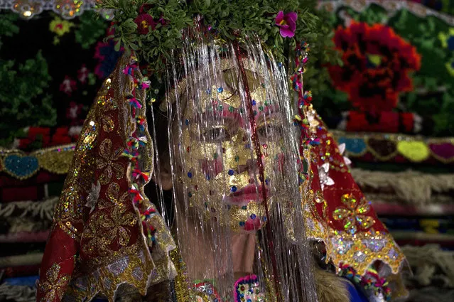 Emilia Pechinkova, a 24-years-old Bulgarian Pomak (Bulgarian speaking Muslims) bride poses for a photograph following the “gelina” or face painting ceremony carried out by female guests and relatives in preparation for her three-day wedding ceremony in the village of Draginovo, 100 kms southeast of Sofia on April 22, 2016. Bulgaria's Muslim population is one of the highest in the European Union. (Photo by Nikolay Doychinov/AFP Photo)