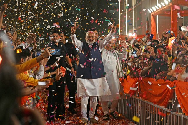 India’s Prime Minister Narendra Modi (C) flashes victory sign as he arrives at the Bharatiya Janata Party (BJP) headquarters to celebrate the party’s win in country's general election, in New Delhi on June 4, 2024. Modi claimed election victory for his party and its allies on June 4, but the opposition said they had “punished” the ruling party to confound predictions and reduce their parliamentary majority. (Photo by Arun Sankar/AFP Photo)