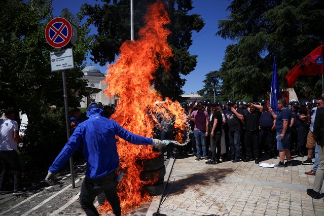 Petrol bombs explode as Albanian opposition supporters protest against the government outside the parliament building, in Tirana, Albania, on June 6, 2024. (Photo by Florion Goga/Reuters)
