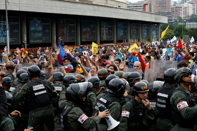Opposition supporters clash with Venezuelan National Guards during a rally to demand a referendum to remove President Nicolas Maduro in Caracas, Venezuela, May 11, 2016. (Photo by Carlos Garcia Rawlins/Reuters)