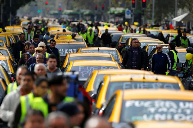Taxis are seen blocking a street during a protest against Uber Technologies Inc. in Santiago, Chile, May 12, 2016. (Photo by Ivan Alvarado/Reuters)