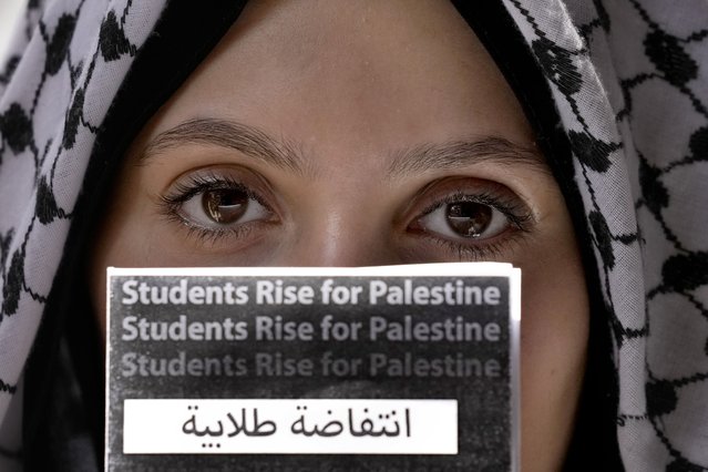 A student holds a placard during a protest inside the American University of Beirut to show support for Palestinians in the Gaza Strip, in Beirut, Lebanon, Tuesday, May 7, 2024. The protesting university students demanded an end to Israel's war in Gaza and its continued attacks in Lebanon, as well as the American University of Beirut to end economic ties with companies that they say are “complicit in the Israeli occupation of Palestinians”. (Photo by Bilal Hussein/AP Photo)