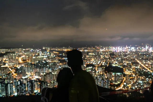 A couple of pro-democracy supporters enjoy a moment as they gather on Lion Rock during mid-autumn festival on September 13, 2019 in Hong Kong, China. (Photo by Anthony Kwan/Getty Images)