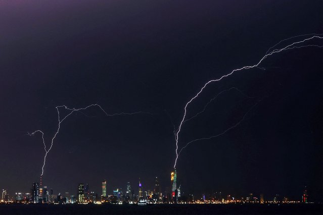 Lightning strikes al-Hamra tower (R) and Liberation tower (L) in Kuwait City during a thunder storm on January 2, 2024. (Photo by Yasser Al-Zayyat/AFP Photo)