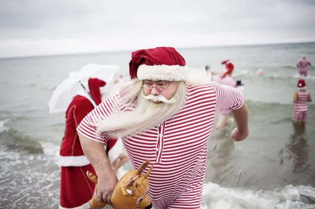 Participants of the World Congress of Santa Clauses 2015 take part in the annual swim at Bellevue beach, north of Copenhagen, Denmark, July 21, 2015. (Photo by Erik Refner/Reuters/Scanpix Denmark)