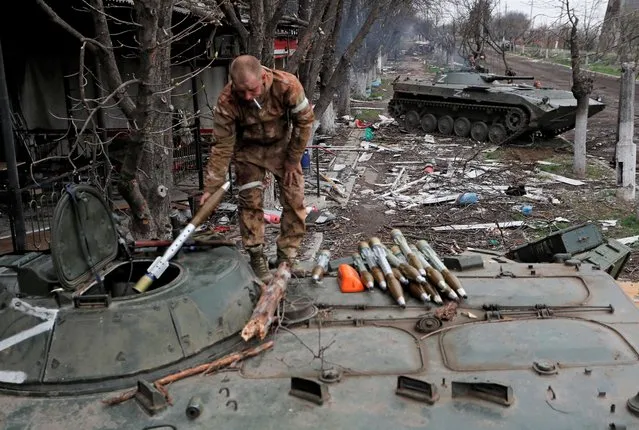 A service member of pro-Russian troops loads rocket-propelled grenades into an infantry combat vehicle during fighting in Ukraine-Russia conflict near a plant of Azovstal Iron and Steel Works company in the southern port city of Mariupol, Ukraine on April 12, 2022. (Photo by Alexander Ermochenko/Reuters)
