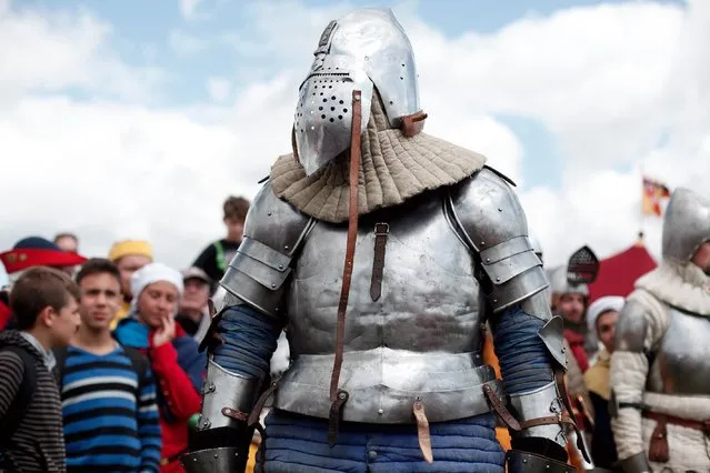 A man wearing an armor attends a reenactment of the Battle of Agincourt, in Agincourt, northern France, Saturday, July 25, 2015. (Photo by Thibault Camus/AP Photo)