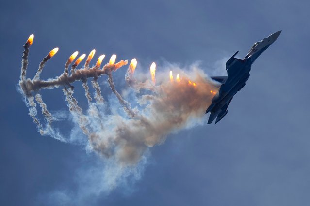 A Sukhoi Su-35S jet fighter of the Russian Knights aerobatic team performs during the International Maritime Defence Show “Fleet-2024” in Kronstadt, outside St. Petersburg, Russia, Friday, June 21, 2024. (Photo by Dmitri Lovetsky/AP Photo)