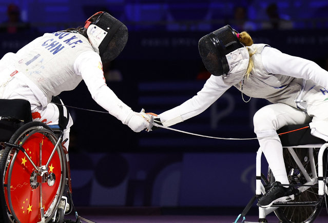 Zou Xufeng of China in action against Eva Andrea Hajmasi of Hungary during the women's foil team wheelchair fencing gold medal match on September 5, 2024. (Photo by Carlos Garcia Rawlins/Reuters)