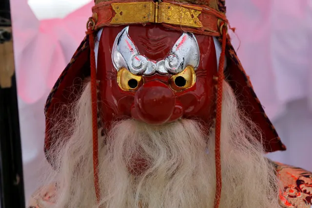A man wearing a mask of a Tengu or Japanese long-nosed goblin, take part in a parade at the Imperial Palace during the Sanno Festival in Tokyo, Japan June 10, 2016. (Photo by Toru Hanai/Reuters)