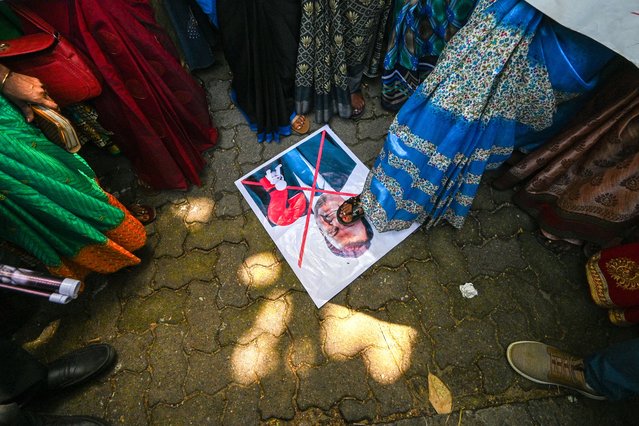 Estate workers reacts as they gather to protest outside the office of Kelani Valley Plantations to assert their demands for fair wages in Colombo on July 9, 2024. (Photo by Ishara S. Kodikara/AFP Photo)