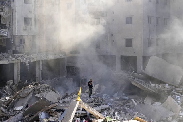 A man stands on the rubble of buildings near the site of the assassination of Hezbollah leader Hassan Nasrallah in Beirut's southern suburbs, Sunday, September 29, 2024. (Photo by Hassan Ammar/AP Photo)