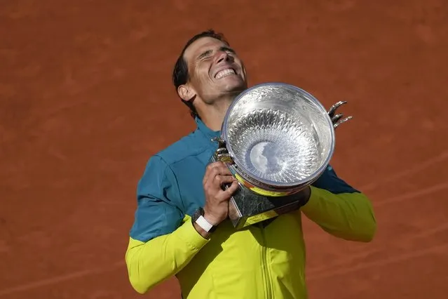 Spain's Rafael Nadal lifts the trophy after winning the final match against Norway's Casper Ruud in three sets, 6-3, 6-3, 6-0, at the French Open tennis tournament in Roland Garros stadium in Paris, France, Sunday, June 5, 2022. (Photo by Christophe Ena/AP Photo)