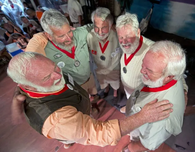 In this Saturday, July 19, 2014, photo provided by the Florida Keys News Bureau, finalists in the 2014 “Papa” Hemingway Look-Alike Contest congratulate each other just before the winner is announced at Sloppy Joe's Bar in Key West, Fla. (Photo by Andy Newman/AP Photo/Florida Keys News Bureau)