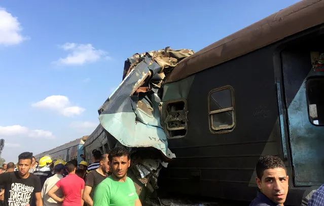 Egyptians look at the crash of two trains that collided near the Khorshid station in Egypt's coastal city of Alexandria, Egypt August 11, 2017. (Photo by Osama Nageb/Reuters)