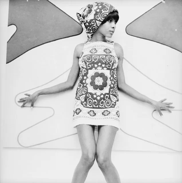 A model wearing a bold print beach dress and scarf, 1966