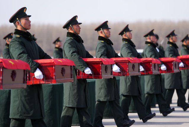 Soldiers escort coffins containing the remains of Chinese People's Volunteers (CPV) martyrs at the Taoxian international airport in Shenyang, northeast China's Liaoning Province, November 28, 2024. The remains of 43 CPV soldiers who lost their lives during the War to Resist U.S. Aggression and Aid Korea (1950-1953) were returned to China on Thursday from the Republic of Korea (ROK). (Photo by Xinhua News Agency/Rex Features/Shutterstock)