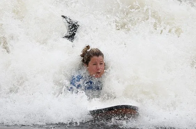 Surfers surf at Surf Snowdonia in Conwy, North Wales, September 3, 2015. (Photo by Andrew Yates/Reuters)