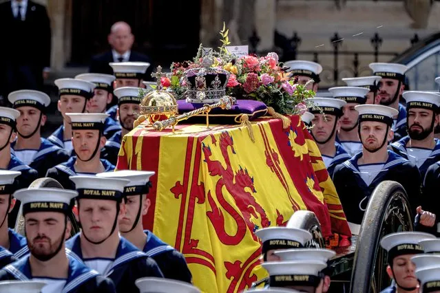 The coffin of Queen Elizabeth II is seen leaving Westminster Abbey on the day of her funeral in London, United Kingdom on September 19, 2022. (Photo by James Forde for The Washington Post)
