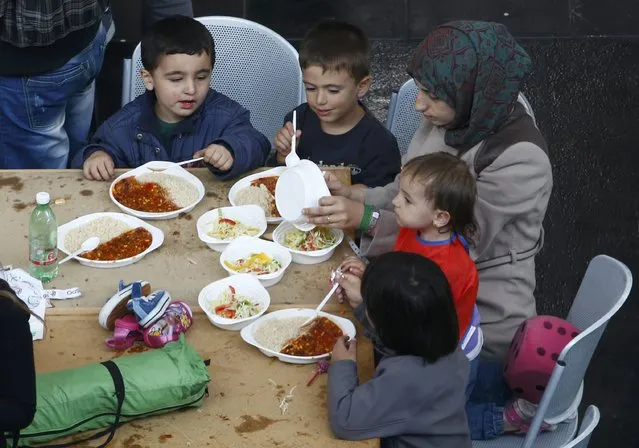 Migrants eat at a makeshift mensa at the fair ground of Munich, Germany September 7, 2015. (Photo by Michaela Rehle/Reuters)