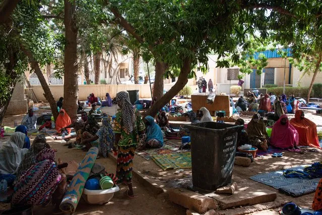 Dozens of women wait on mats outside the Ossaka Gazoby central maternity hospital in Niamey on May 8, 2020. The Niger health authorities on May 7, 2020 launched an appeal to the population of Niamey to go back to the health centres, which are less frequented since the arrival of the COVID019 coronavirus in Niger and the fear of being contaminated. (Photo by Nicolas Réméné/AFP Photo)