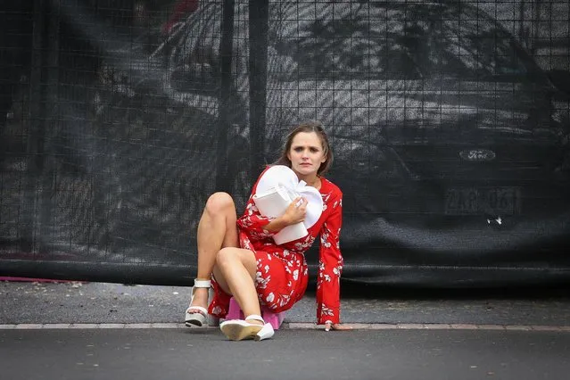 A reveller seems to find it difficult to get back on to her feet during Caulfield Cup Day at Caulfield Racecourse on October 21, 2017 in Melbourne, Australia. (Photo by Splash News and Pictures)