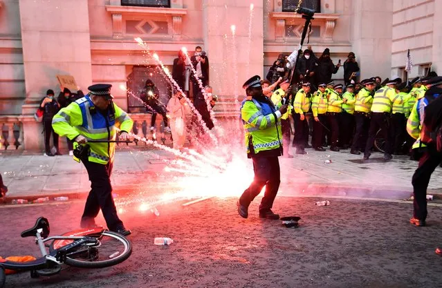 A firework explodes as police officers clash with demonstrators in Whitehall during a Black Lives Matter protest in London, following the death of George Floyd who died in police custody in Minneapolis, London, Britain, June 7, 2020. (Photo by Dylan Martinez/Reuters)