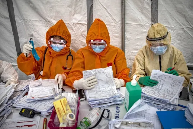 Medical personnel in protective clothing work inside a makeshift nurses station at a parking lot converted into a COVID-19 isolation facility, at the National Kidney and Transplant Institute Hospital on April 30, 2020 in Quezon city, Metro Manila, Philippines. Parts of the Philippines, including the capital Manila, remain on lockdown as authorities continue to struggle with the growing number of COVID-19 cases. Land, sea, and air travels have been suspended, while government work, schools, businesses, and public transportation have been ordered to shutdown in a bid to keep some 55 million people at home. The Philippines' Department of Health has so far confirmed 8,488 cases of the coronavirus in the country, with at least 568 recorded fatalities. (Photo by Ezra Acayan/Getty Images)