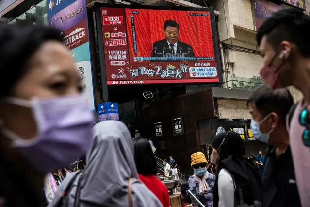 Chinese President Xi Jinping is seen on a TV in a street in Hong Kong on October 16, 2022, as he delivers the opening speech of the ruling Communist Party’s 20th party congress in Beijing. (Photo by Isaac Lawrence/AFP Photo)