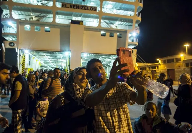 Ihab, a 30-year old Syrian migrant from Deir Al Zour, war-torn Syria, takes a selfie with his wife Abeer after disembarking from a passenger ship in Athens, Greece September 12, 2015. The crossing from Turkey to Lesbos and the eventual trip to Athens is only the beginning for Ihab and other families. Ahead lies a trek north through Greece, up via Macedonia and Serbia to Hungary and on to Austria, Germany and more industrialised countries. (Photo by Zohra Bensemra/Reuters)