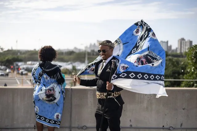 A Zulu woman and a man clad in traditional dresses are seen at the Moses Mabhida Stadium in Durban on October 29, 2022, as they arrive for the handover of the official certificate of recognition for the Zulu King Misuzulu. King Misuzulu, 49, will be formally acknowledged as monarch by President Cyril RamaphosaIt in the first Zulu coronation since South Africa became a democracy in 1994. (Photo by Marco Longari/AFP Photo)